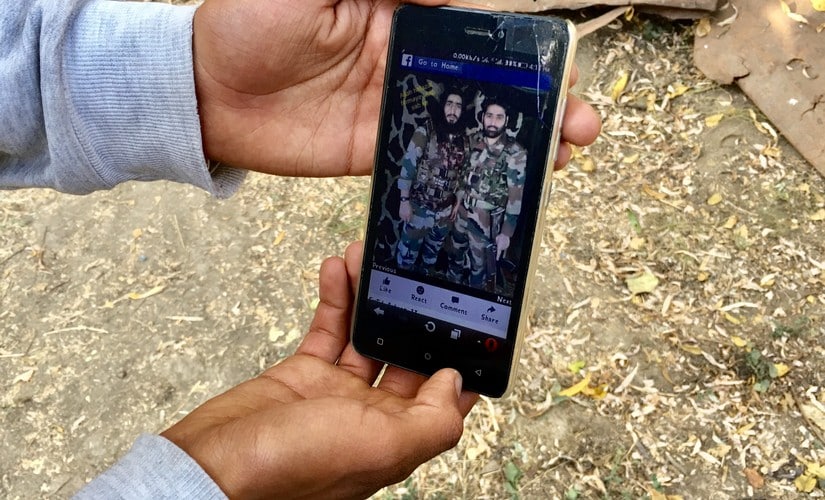 A teenager shows a picture of Falahi along with another militant, on his mobile phone. Sameer Yasir/Firstpost