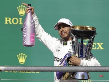 Mercedes driver Lewis Hamilton holds his trophy after winning the US Grand Prix. AP
