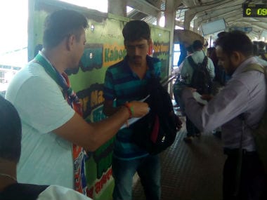 MNS leader distributes pamphlets at a railway station in Mumbai. Image courtesy: Sanjay Sawant/Firstpost