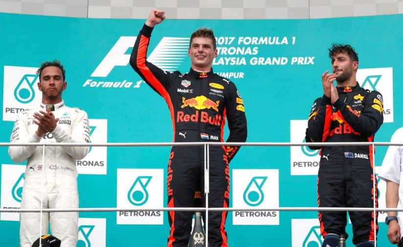 Redbull’s Max Verstappen celebrates winning the race between teammate Daniel Ricciardo and Mercedes Lewis Hamilton. Reuters