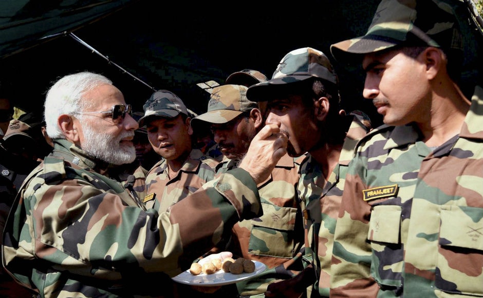 Modi offered sweets and exchanged greetings with the jawans. Addressing the jawans, he said like everyone else, he too wishes to spend Diwali with his family. PTI Modi offered sweets and exchanged greetings with the jawans. Addressing the jawans, he said like everyone else, he too wishes to spend Diwali with his family. PTI