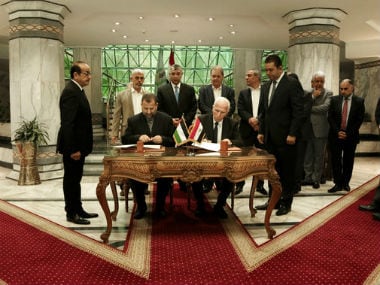 Representatives of the Fatah and Hamas sign the deal in Cairo on Thursday. AP