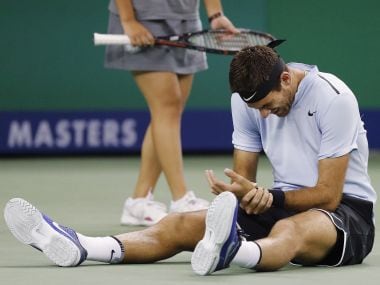 Juan Martin del Potro of Argentina holds his hand in pain after falling on the court during his men's singles quarterfinals match against Viktor Troicki of Serbia in the Shanghai Masters tennis tournament at Qizhong Forest Sports City Tennis Center in Shanghai, China, Friday, Oct. 13, 2017. (AP Photo/Andy Wong)