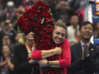 Simona Halep of Romania hugs a floral bouquet in the shape of the number one after beating Jelena Ostapenko of Latvia in their women's singles semifinal in the China Open tennis tournament at the Diamond Court in Beijing, Saturday, Oct. 7, 2017. Halep achieved the women's world #1 ranking with the victory. (AP Photo/Mark Schiefelbein)