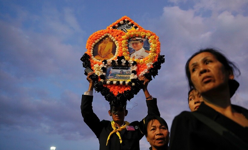 Mourners wait just before the sunset to go through security check for Royal Cremation ceremony of Thailand's late King Bhumibol Adulyadej near the Grand Palace in Bangkok. Reuters