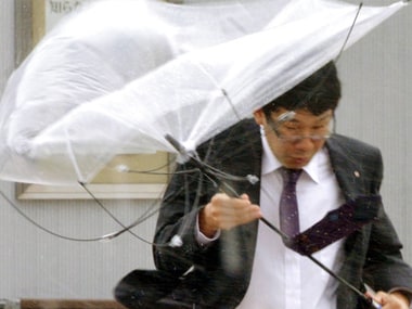 A man walks in a strong wind caused by a powerful typhoon in Iwaki, Fukushima prefecture on Monday. AP