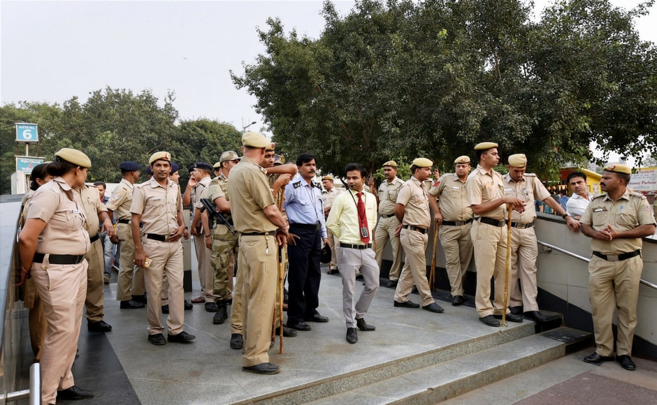Police and security personnel deployed at an entrance gate of Rajiv Chowk Metro Station during the launch of Delhi Congress committee's weeek-long " Kejriwal+BJP, Stop Politics, Save Metro" campaign in New Delhi on Wednesday. PTI