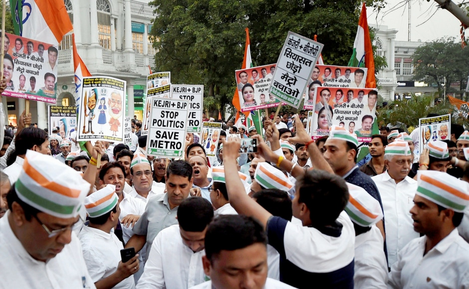 DPCC President Ajay Maken with party workers during the launch of their week-long " Kejriwal+BJP, Stop Politics, Save Metro" campaign, outside Rajiv Chowk Metro Station in New Delhi on Wednesday. PTI