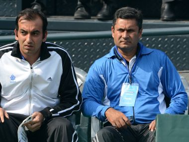 India tennis coach Zeeshan Ali (R) and tennis player Purav Raja watch teammate Virali-Murugesan Ranjeet in his match against South Korean tennis player Cho Min-Hyeok during the first singles match of the Davis Cup at the Delhi Lawn Tennis Association (DLTA) tennis courts in New Delhi on February 1, 2013. The South Korean won with a score of 6-1, 6-0, 6-1. AFP PHOTO/ Prakash SINGH / AFP PHOTO / PRAKASH SINGH