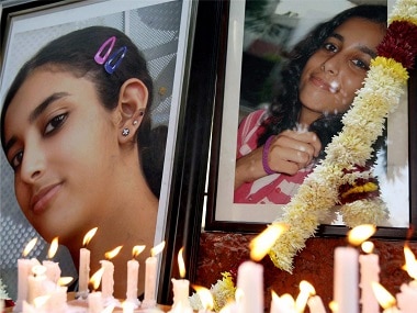 Friends and relatives of Aarushi Talwar light candles near her portrait. PTI