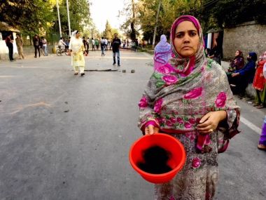 A woman protester in Bagat area of Srinagar showing the hair of a chopped braid of one of her relatives. Image procured by Sameer Yasir.