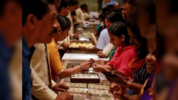 Gold prices decline by Rs 235 to Rs 32,980 per 10 gram on muted demand from local jewellers; silver dips too