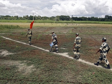 Border Security Force (BSF) soldiers walk across the open border with Bangladesh. Reuters