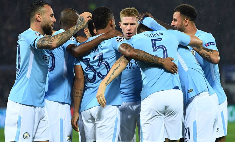 (FILES) This file photo taken on September 13, 2017 shows Manchester City's English defender John Stones (2R) celebrates with teammates after scoring a goal during the UEFA Champions League Group F football match between Feyenoord Rotterdam and Manchester City at the Feyenoord Stadium in Rotterdam, on September 13, 2017. Manchester City and Napoli are the two most prolific teams in Europe's five major leagues, making the October 17 Champions League encounter at the Etihad Stadium a genuinely mouth-watering prospect. / AFP PHOTO / Emmanuel DUNAND
