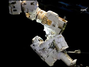 NASA astronauts conduct a seven hour long spacewalk to install a new external camera system NASA astronauts conduct a seven hour long spacewalk to install a new external camera system