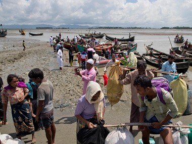 Rohingya Muslims from Myanmar disembark from boats as they continue their journey to Bangladesh. AP