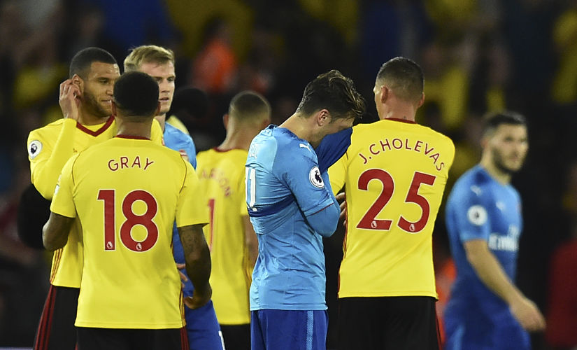 Arsenal's German midfielder Mesut Ozil (C) reacts at the final whistle during the English Premier League football match between Watford and Arsenal at Vicarage Road Stadium in Watford, north of London on October 14, 2017. Watford won 2-1. / AFP PHOTO / Glyn KIRK / RESTRICTED TO EDITORIAL USE. No use with unauthorized audio, video, data, fixture lists, club/league logos or 'live' services. Online in-match use limited to 75 images, no video emulation. No use in betting, games or single club/league/player publications. /
