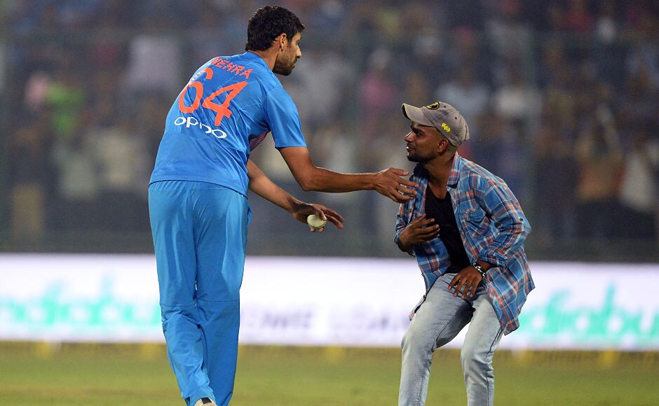 With victory assured, Virat Kohli asked Ashish Nehra to bowl the final over of the match. A fan managed to get on the field and take the blessing of the retiring Ashish Nehra. AFP With victory assured, Virat Kohli asked Ashish Nehra to bowl the final over of the match. A fan managed to get on the field and take the blessing of the retiring Ashish Nehra. AFP