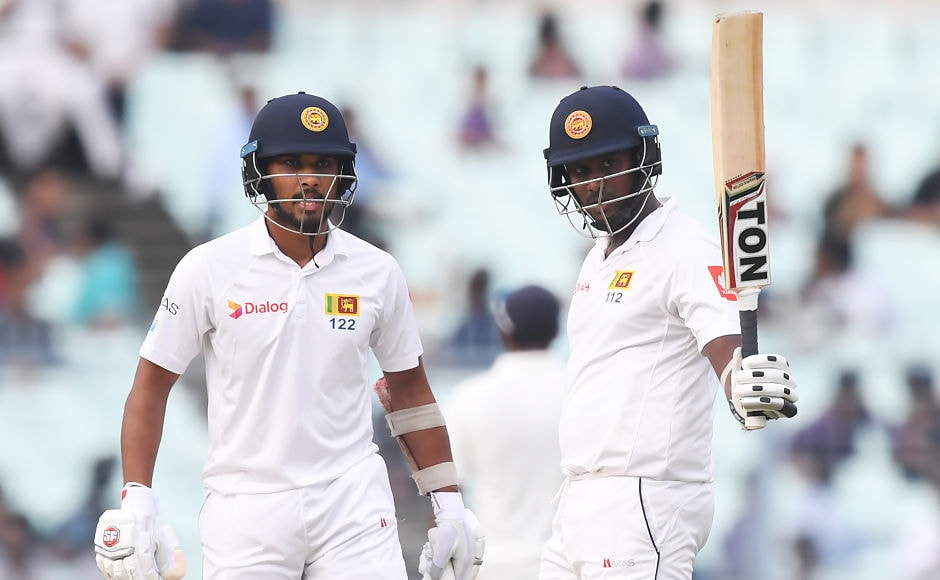 Former captain Angelo Mathews celebrates after scoring a half-century as captain Dinesh Chandimal looks on. Umesh Yadav removed Mathews after he made 52. Sri Lanka end the day with just seven runs behind India's score and six wickets in hand. AFP Former captain Angelo Mathews celebrates after scoring a half-century as captain Dinesh Chandimal looks on. Umesh Yadav removed Mathews after he made 52. Sri Lanka end the day with just seven runs behind India's score and six wickets in hand. AFP