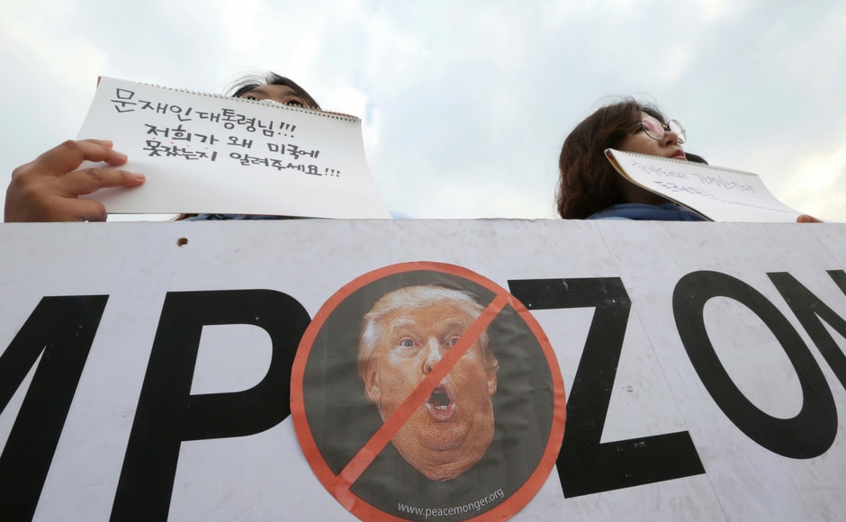 Thousands of protesters took to streets in South Korea on Sunday to protest against Donald Trump's upcoming visit to the country. AP Thousands of protesters took to streets in South Korea on Sunday to protest against Donald Trump's upcoming visit to the country. AP
