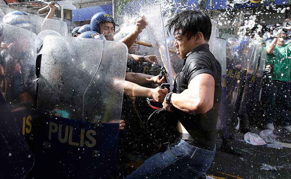Police try to grab a protester as they are dispersed while to get near the US Embassy in Manila. Protesters believe that Trump's visit would move the country closer to the US and form a relationship that could see the Philippines dragged into any conflict in the region, such as with North Korea. AP Police try to grab a protester as they are dispersed while to get near the US Embassy in Manila. Protesters believe that Trump's visit would move the country closer to the US and form a relationship that could see the Philippines dragged into any conflict in the region, such as with North Korea. AP