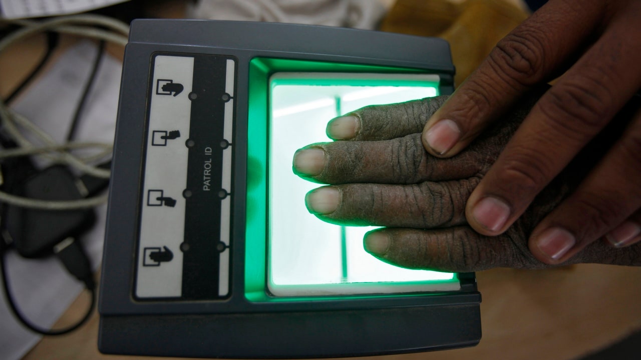 A villager goes through the process of a fingerprint scanner for the Unique Identification (UID) database system at an enrolment centre at Merta district in the desert Indian state of Rajasthan February 22, 2013. In a more ambitious version of programmes that have slashed poverty in Brazil and Mexico, the Indian government has begun to use the UID database, known as Aadhaar, to make direct cash transfers to the poor, in an attempt to cut out frauds who siphon billions of dollars from welfare schemes. Picture taken February 22, 2013. REUTERS/Mansi Thapliyal (INDIA - Tags: BUSINESS SOCIETY POVERTY SCIENCE TECHNOLOGY) - GM1E92S1B2G01