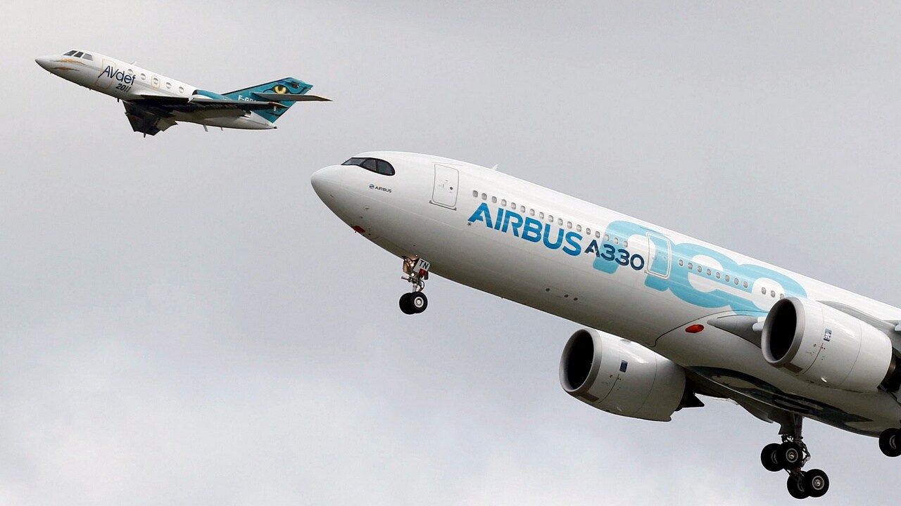 An Airbus A330neo aircraft lands as a Dassault Aviation Falcon jet of AVdef (Aviation Defense Service) flies nearby during its maiden flight event in Colomiers near Toulouse. Reuters.