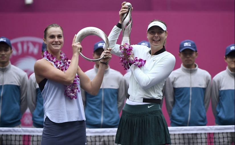 Maria Sharapova (R) and second-placed Aryna Sabalenka pose with their trophies after the women's singles final match at the Tianjin Open. AFP