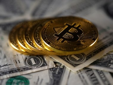 Bitcoin (virtual currency) coins placed on Dollar banknotes are seen in this illustration picture. Reuters