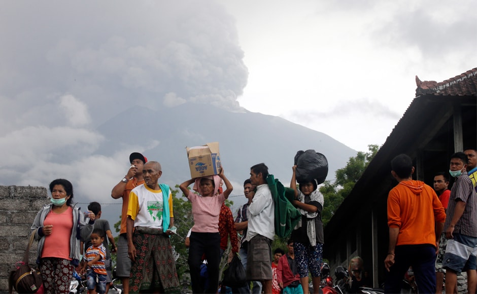 Villagers carry their belongings during an evacuation following the eruption of Mount Agung. About 25,000 people living close to the mountain have already left their homes and evacuated since the volcano first started to spew smoke on Tuesday. AP Villagers carry their belongings during an evacuation following the eruption of Mount Agung. About 25,000 people living close to the mountain have already left their homes and evacuated since the volcano first started to spew smoke on Tuesday. AP