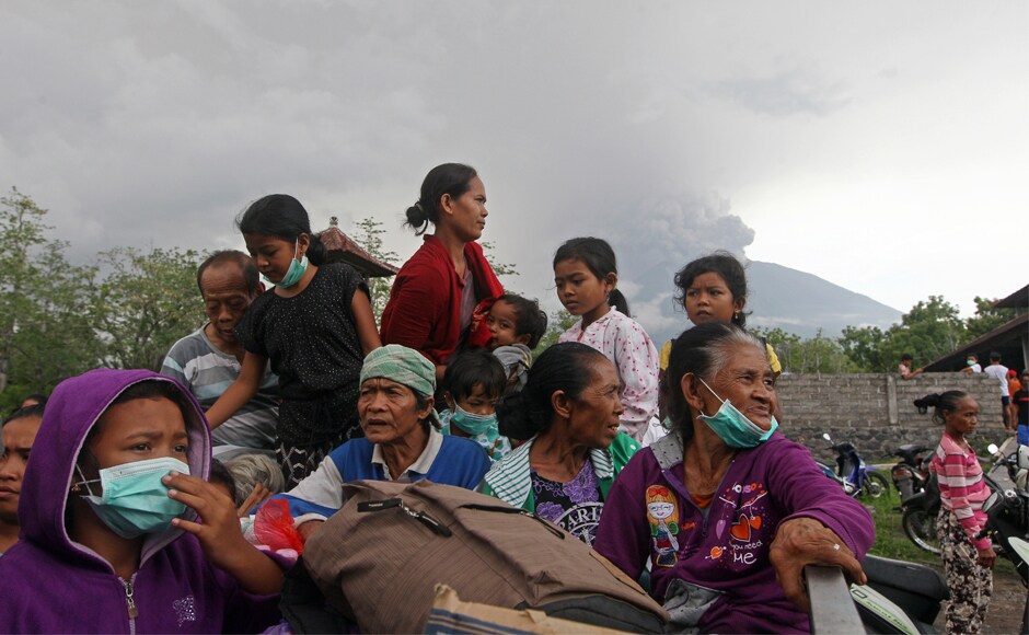 Villagers sit on a truck during an evacuation following the eruption of Mount Agung. National disaster agency spokesman Sutopo Purwo Nugroho also called for people to stay calm. AP Villagers sit on a truck during an evacuation following the eruption of Mount Agung. National disaster agency spokesman Sutopo Purwo Nugroho also called for people to stay calm. AP