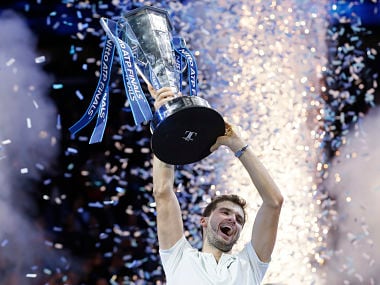Grigor Dimitrov of Bulgaria lifts the trophy after beating David Goffin of Belgium in their ATP World Tour Finals singles final tennis match at the O2 Arena in London, Sunday Nov. 19, 2017. (AP Photo/Tim Ireland)