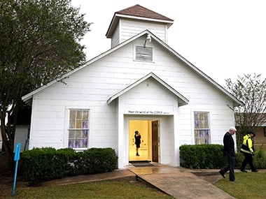 A member of the media walks inside the First Baptist Church of Sutherland Springs where 26 people were killed. Reuters