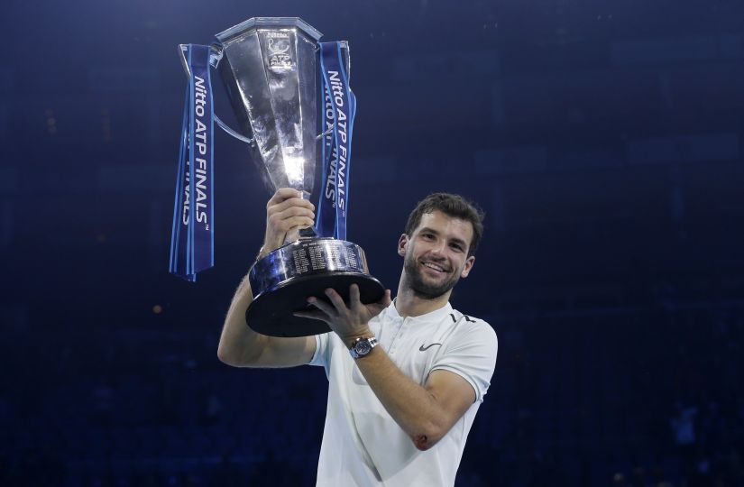 Grigor Dimitrov lifts the trophy after beating David Goffin in their ATP World Tour Finals. AP