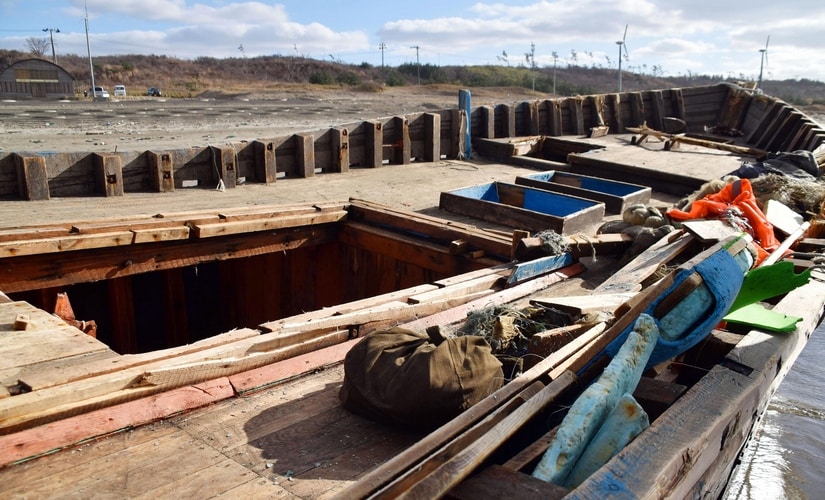 In this Monday, Nov. 27, 2017, photo, an unidentified boat is pictured in Oga, Akita prefecture, northern Japan after being washed ashore. Japan is urging local authorities and fishermen to be on the alert after several boats thought to be from North Korea were found on its northern coast. AP