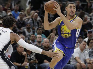 Golden State Warriors guard Klay Thompson drives to the base past San Antonio Spurs guard Patty Mills. AP
