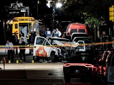 Authorities near a damaged Home Depot truck after a motorist drove onto a bike path near the World Trade Center memorial, striking and killing 8 people. AP