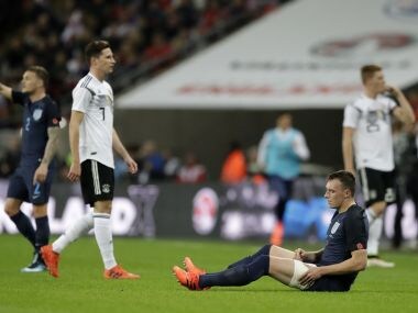England's Phil Jones sits on the ground injured just before he is replaced during an international friendly. AP