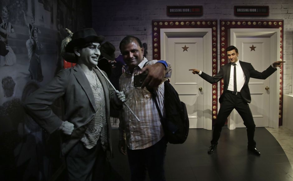 A visitor takes a selfie with a wax figure of Bollywood actor Raj Kapoor (L) as the wax figure of actor Ranbir Kapoor is seen in the background. AP A visitor takes a selfie with a wax figure of Bollywood actor Raj Kapoor (L) as the wax figure of actor Ranbir Kapoor is seen in the background. AP