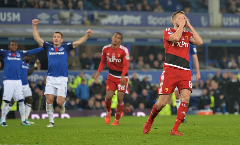 Watford's Tom Cleverley looks dejected after missing a penalty as Everton's Leighton Baines celebrates. Reuters