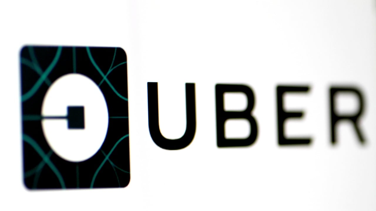 The Uber logo is seen on a screen. Image: Reuters