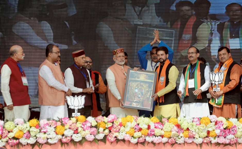 Modi honoured by BJP leader Anurag Thakur during the election rally at Una on Sunday. PTI Modi honoured by BJP leader Anurag Thakur during the election rally at Una on Sunday. PTI
