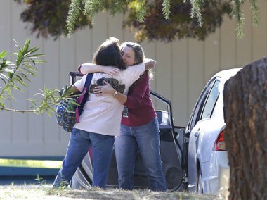 Two women embrace outside Rancho Tehama Elementary School, where a gunman opened fire Tuesday. AP