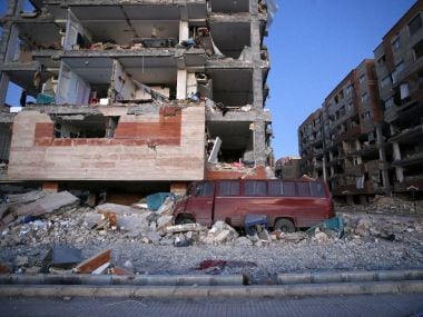 A photo given by the Iranian Students News Agency, ISNA, shows destroyed buildings and a car buried under the rubble after the 7.3 earthquake. AP