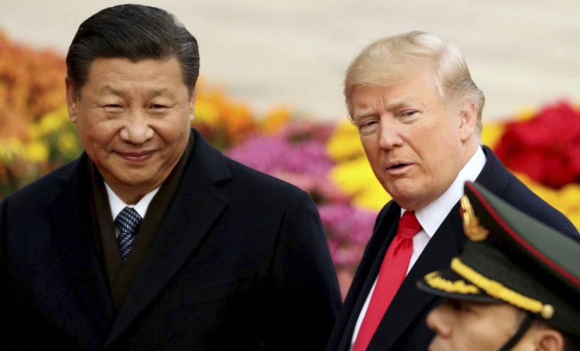 US President Donald Trump and Chinese leader Xi Jinping participate in a welcome ceremony at the Great Hall of the People on Thursday. AP