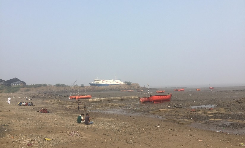 Fisherman seen in Ghogha with the Ro-Ro ferry service in the background. Firstpost/Parth MN