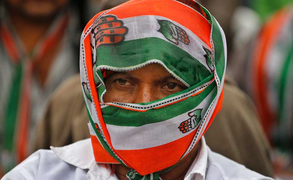 Two public meetings were scheduled at Jinn Mill Ground at Dhrangadhra and MB Shah College Ground at Wadhwan in Surendranagar. A Congress supporter covers himself with the party's scarf during a rally in Dhrangadhra. AP Two public meetings were scheduled at Jinn Mill Ground at Dhrangadhra and MB Shah College Ground at Wadhwan in Surendranagar. A Congress supporter covers himself with the party's scarf during a rally in Dhrangadhra. AP