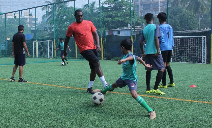 Emile Heskey takes part in a coaching session with local kids in Mumbai. 