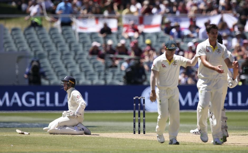 England's Craig Overton, left, falls to his knees after being hint by a delivery from Australia's Pat Cummins, right. (AP Photo/Rick Rycroft) England's Craig Overton, left, falls to his knees after being hint by a delivery from Australia's Pat Cummins, right. (AP Photo/Rick Rycroft)