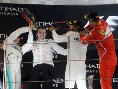Valtteri Bottas, Lewis Hamilton and Sebastian Vettel spray champagne as they celebrate after the Abu Dhabi race. Reuters